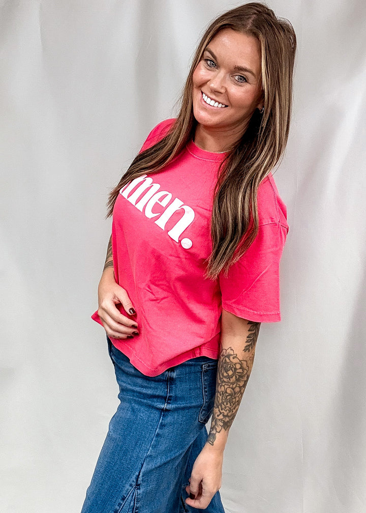 A woman modeling a bright pink t-shirt with &