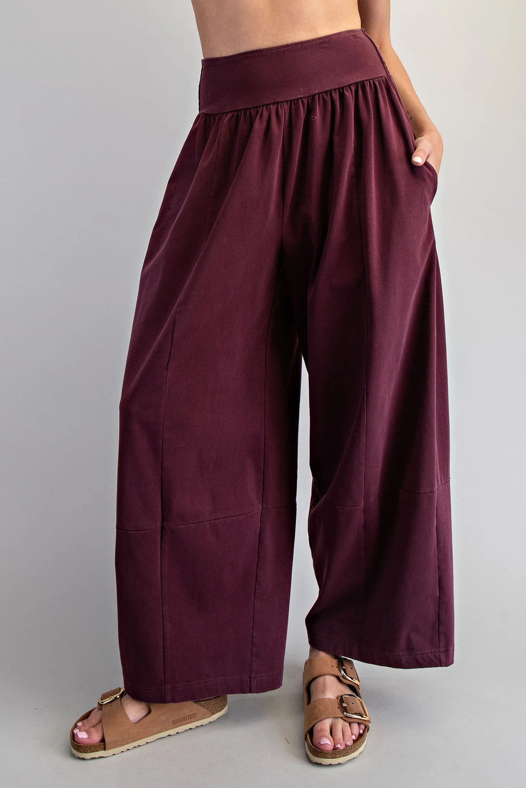 Maroon wide-leg pants worn by a person on a plain background