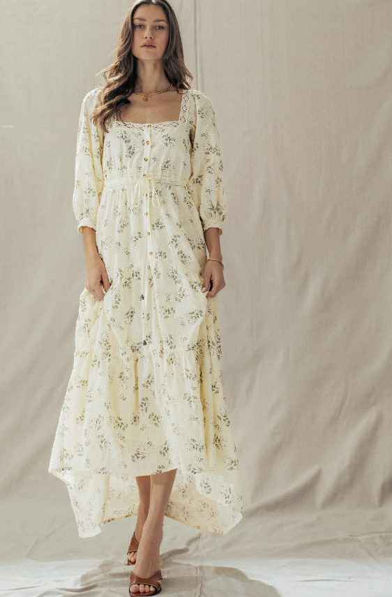 Woman wearing a floral dress against a plain background