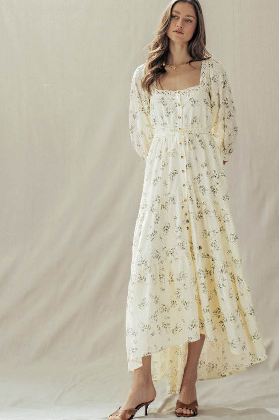 Woman wearing a floral dress against a plain background