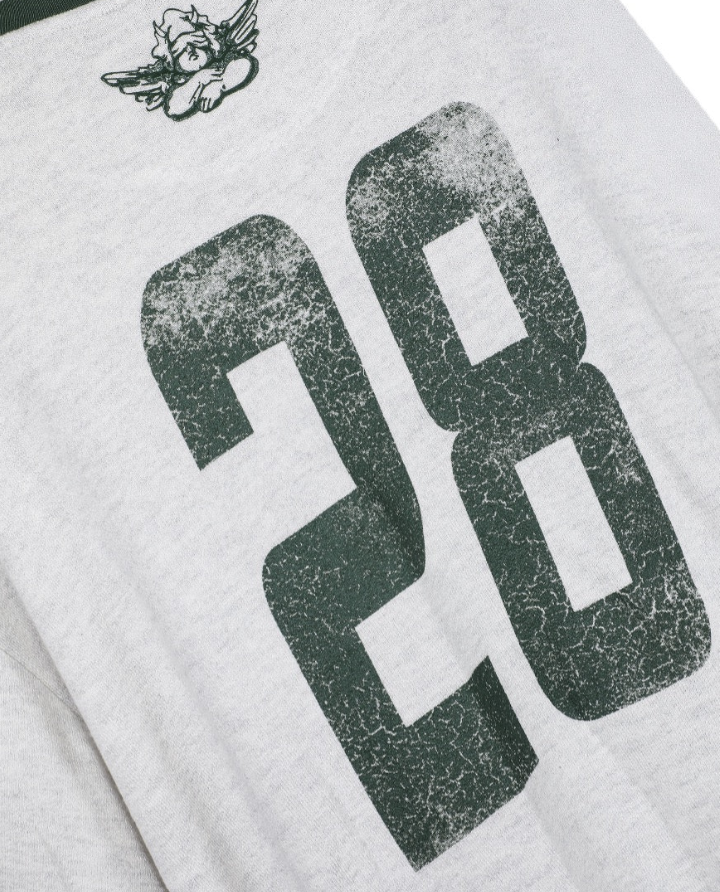 Close-up of a light gray heather t-shirt featuring a large distressed dark green number 28 on the front and a small dark green winged mascot logo near the top left.