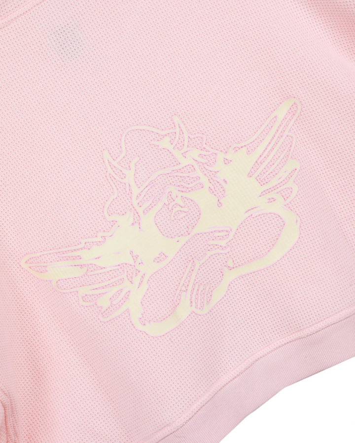 Pink sweatshirt with a green logo on a pink background