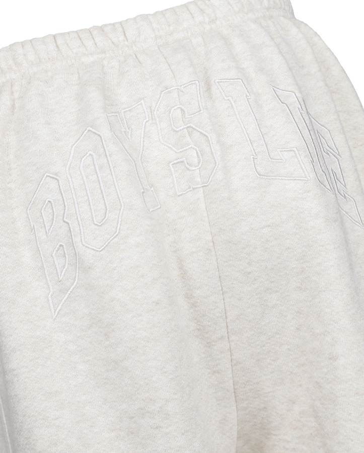Close-up of light heather gray sweatpants with a tonal embroidered outline logo reading &