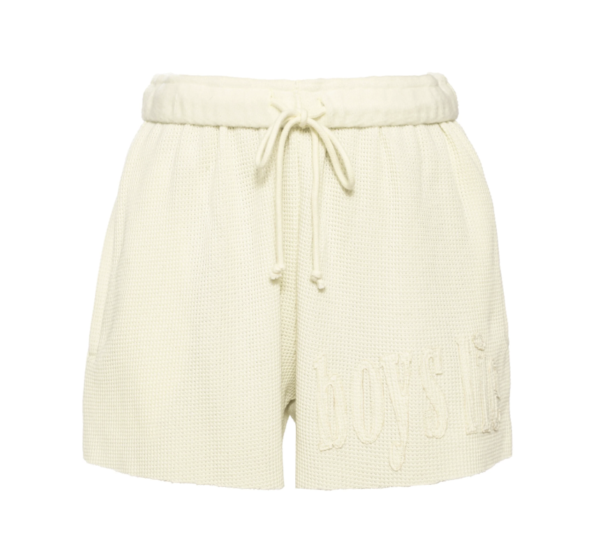 Butter yellow shorts on plain background