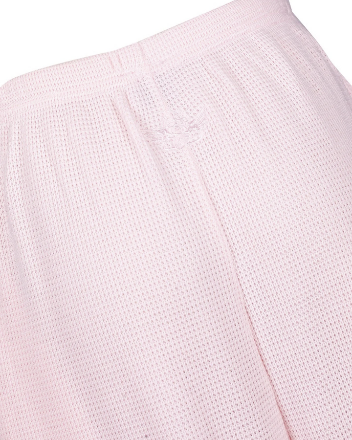 Close-up of light pink mesh fabric with a subtle embroidered logo on the waistband.