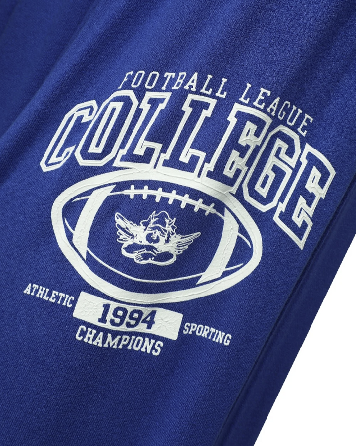 Close-up of a royal blue athletic t-shirt featuring a white graphic print that reads &