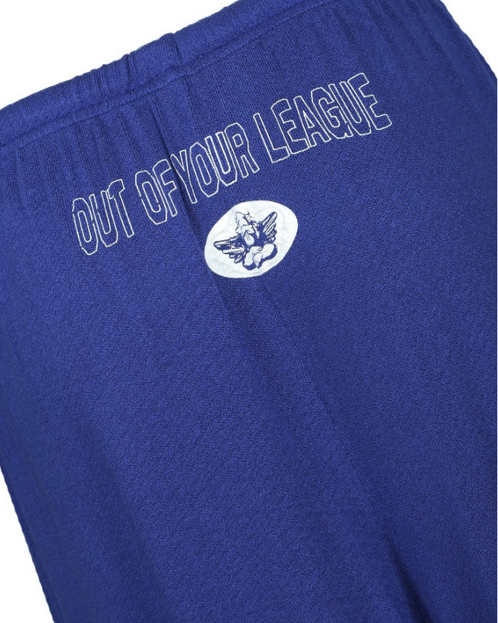 Close-up of royal blue athletic shorts with white embroidered text reading &