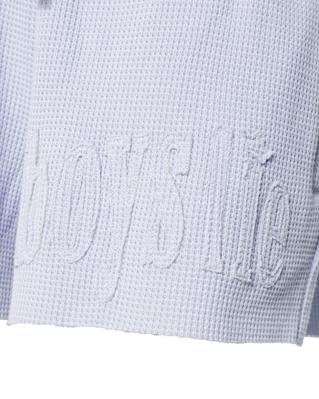 Close-up of a textured light blue fabric with &