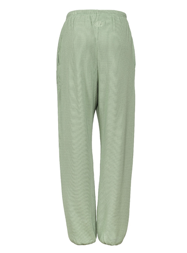 Light sage green wide-leg trousers with a textured chevron pattern, featuring an elastic waistband and side pockets, shown against a plain white background.