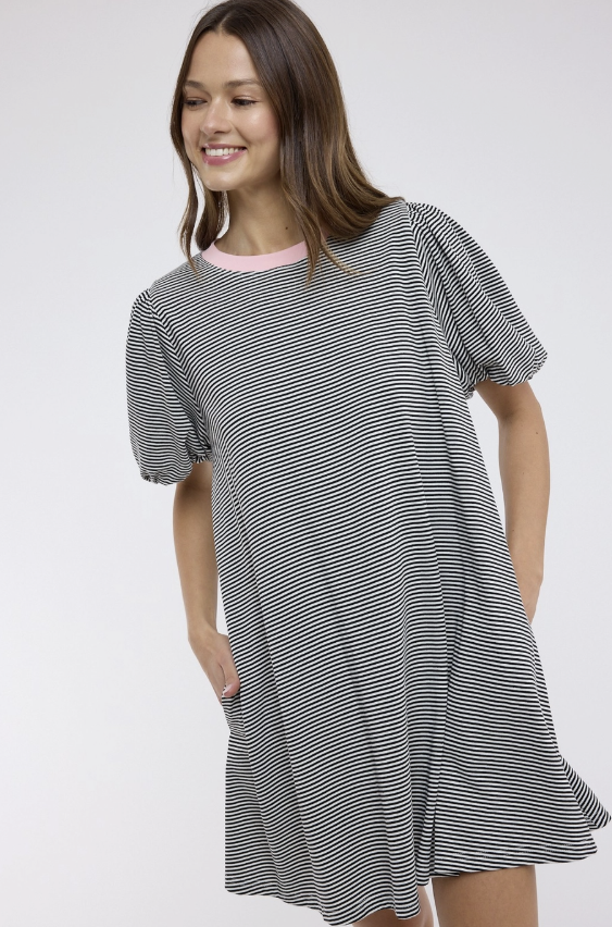 Woman wearing a black and white striped dress on a white background