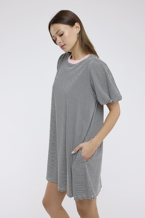 Woman wearing a gray and white striped dress on a white background