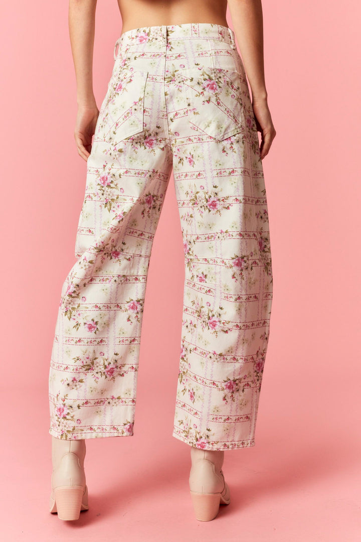 Floral patterned pants on a pink background