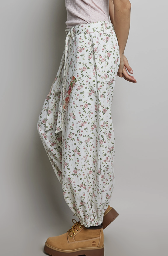 Woman wearing balloon pants on plain background