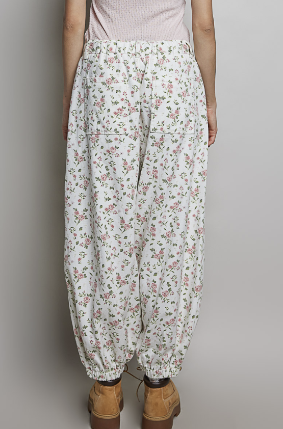 Woman wearing balloon pants on plain background