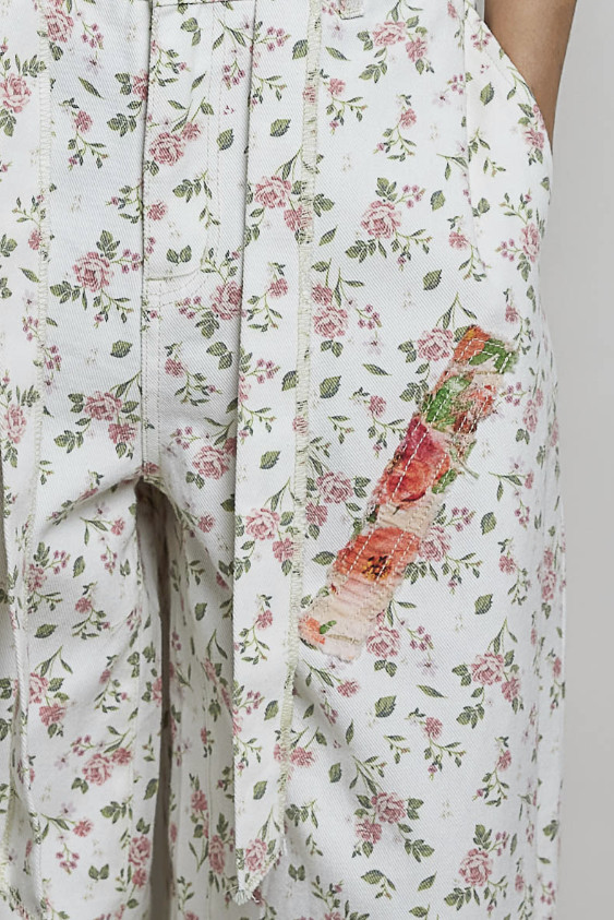 Close up of floral pants on plain background