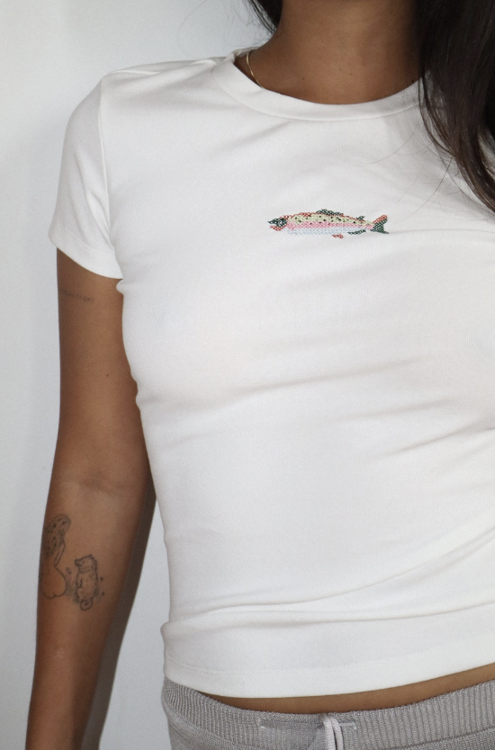 White t-shirt with a small graphic on a plain background