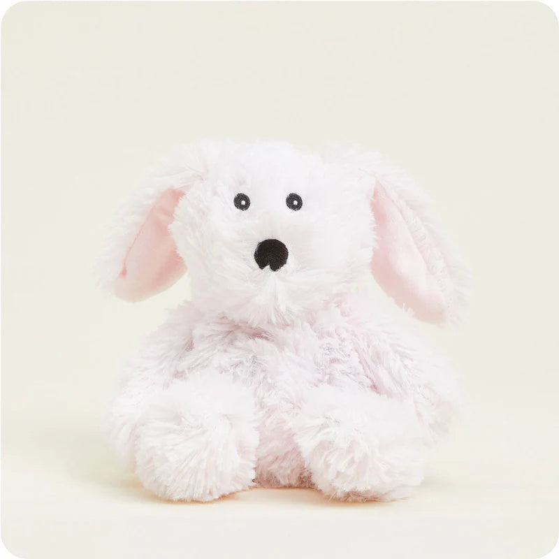 White plush dog toy with pink ears on a light beige background