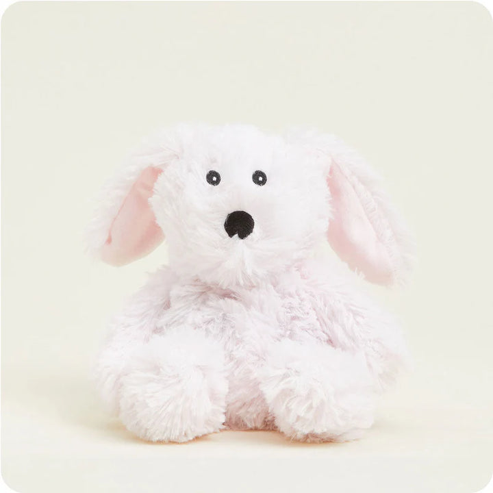 White plush dog toy with pink ears on a light beige background