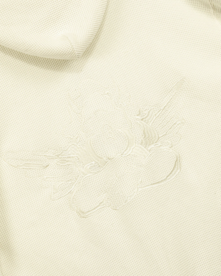 Close-up of a textured cream fabric with a subtle pattern