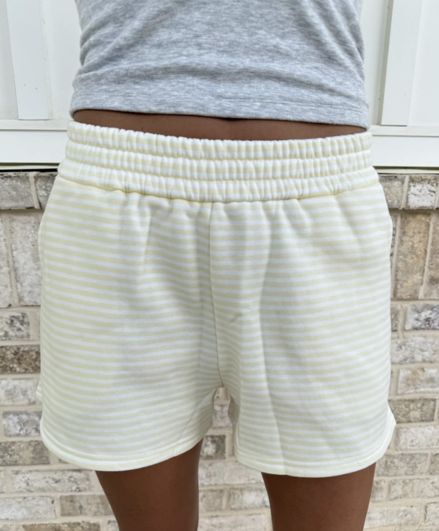 Woman wearing yellow and white stripe shorts