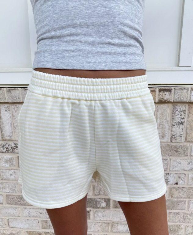 Woman wearing yellow and white stripe shorts