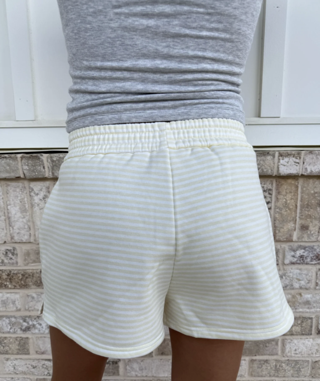Woman wearing yellow and white stripe shorts