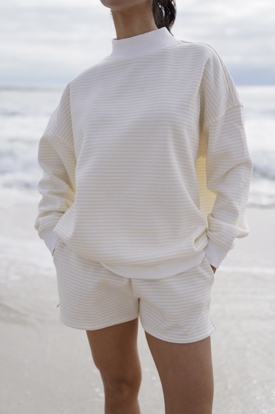 Woman wearing yellow stripe set on beach