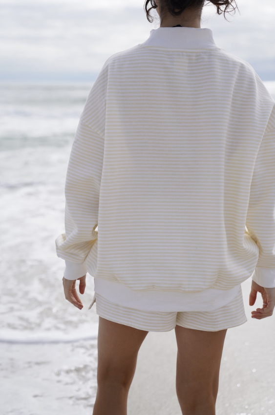 Woman wearing matching yellow stripe set on the beach