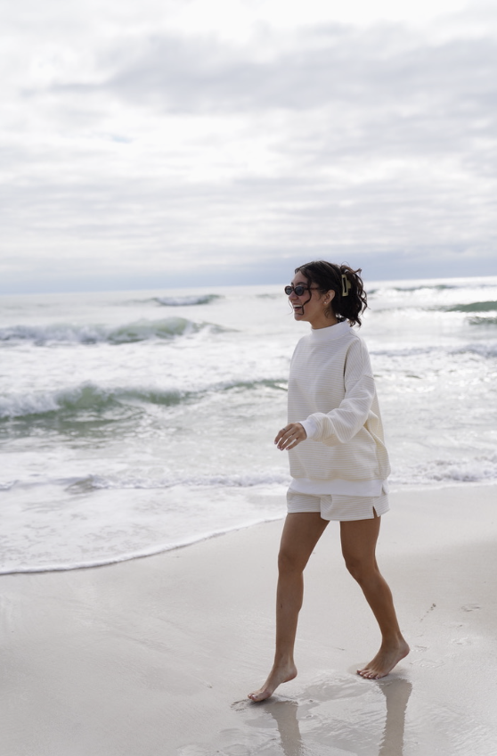 Woman wearing matching yellow stripe set on the beach