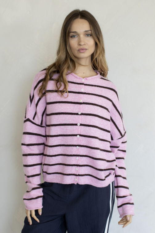 Woman wearing pink and brown stripe cardigan on plain background
