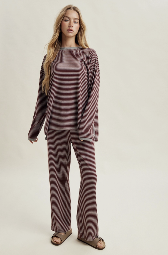Woman wearing matching burgundy and heather grey stripe set on plain background