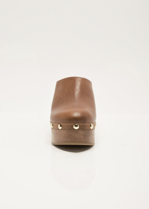 Single leather clog with stud details and wooden bottom on plain background