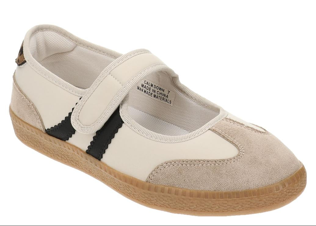 Single sneaker with velcro closer and black stripes on white background