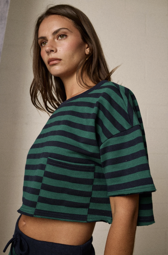 Woman wearing green and blue stripe set standing in studio setting
