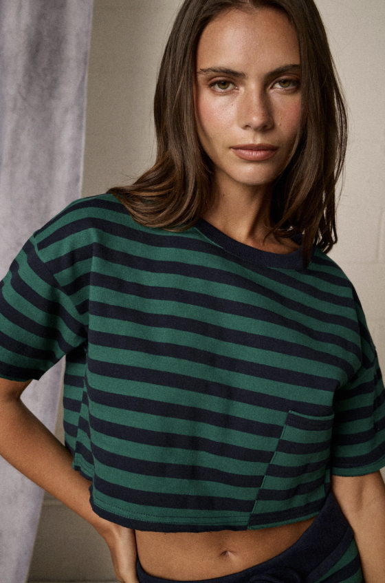 Woman wearing green and blue stripe set in studio setting