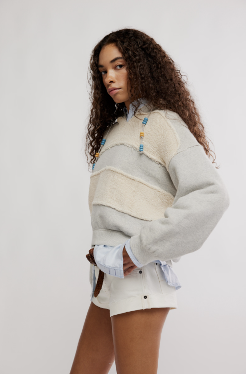 Woman wearing a patterned sweater with a plain background