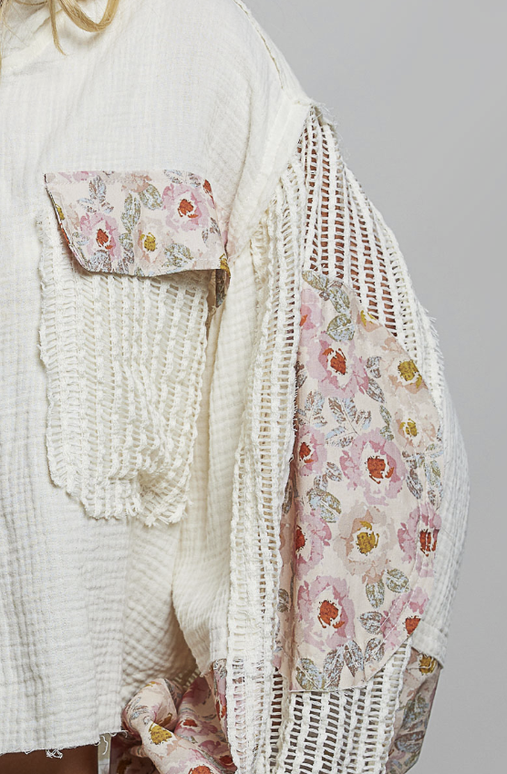 Woman wearing beige and floral waffle knit hoodie on plain background