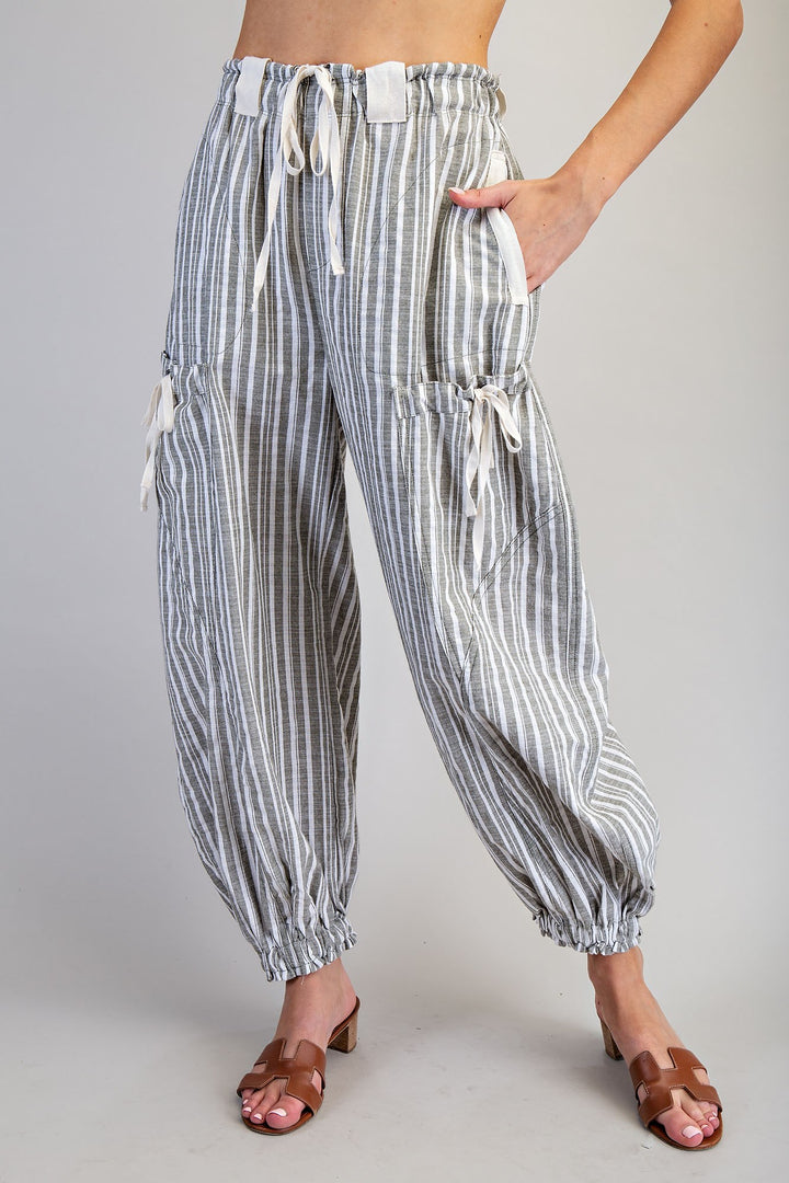 Striped pants worn by a person on a plain background