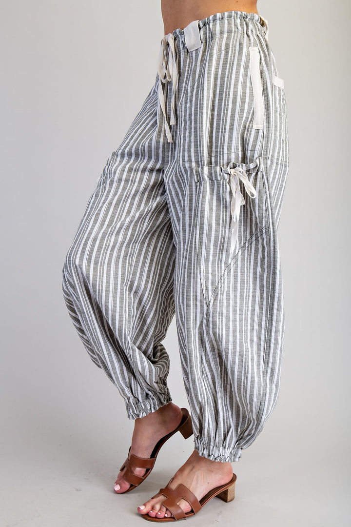 Striped harem pants worn by a person on a plain background