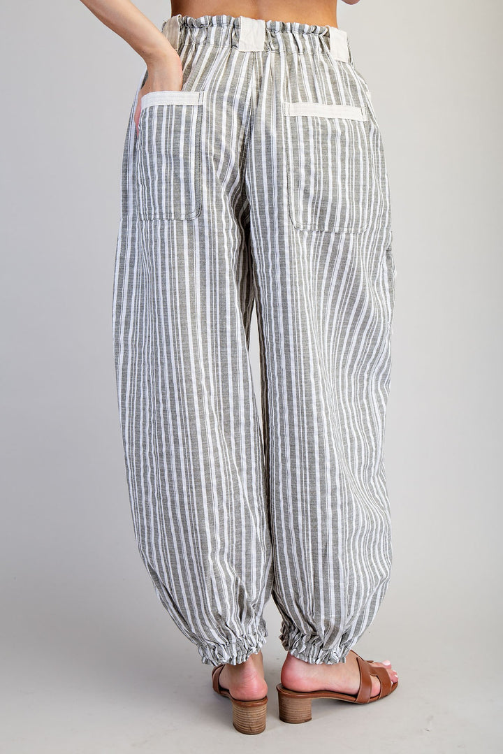 Striped pants worn by a person on a plain background