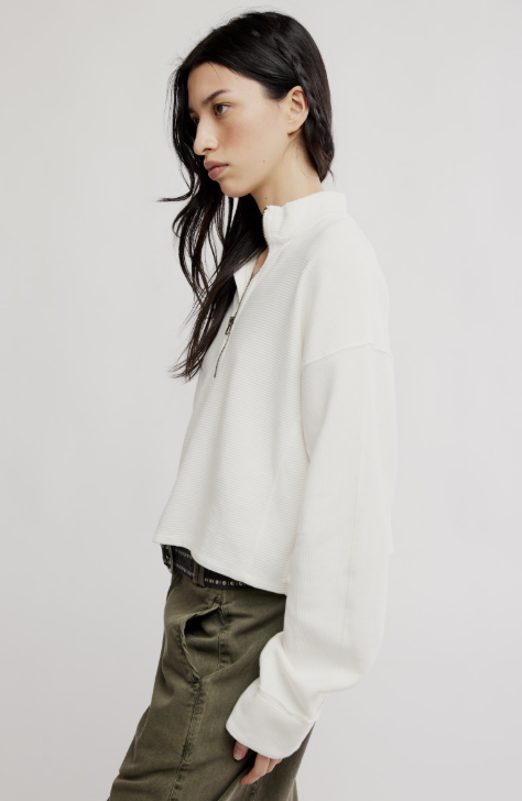 Woman wearing white top and green pants on white background
