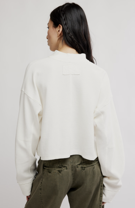Woman wearing white top and green pants on white background