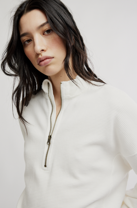 Woman wearing white top on white background