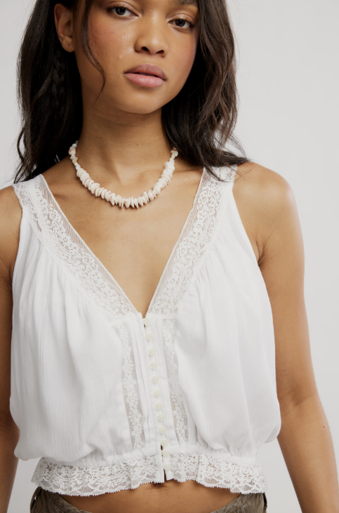 Woman wearing white tank on white background