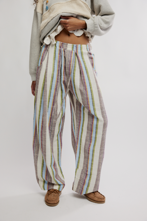 Person wearing colorful striped pants on a white background
