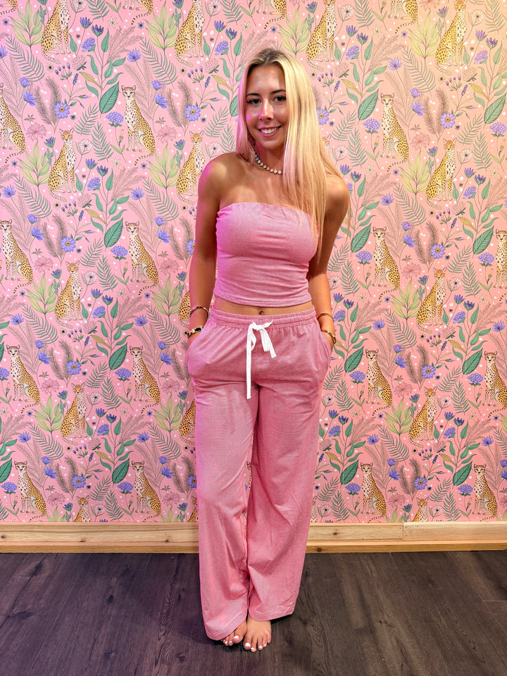 Person wearing a pink outfit on a pink patterned floor