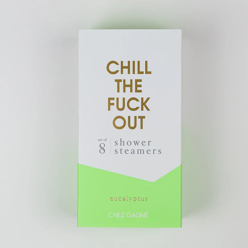 A rectangular product box for shower steamers on a light gray background. The box is white on top with large gold text reading &