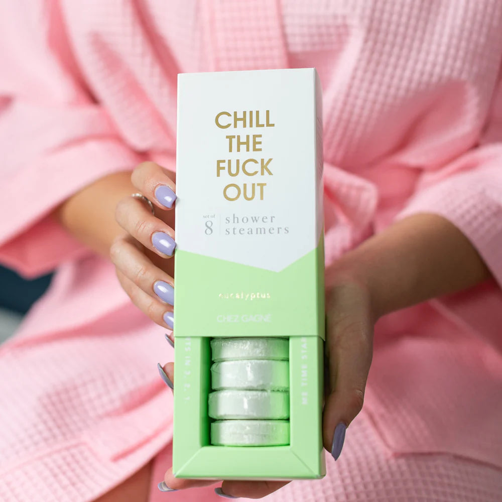 A person in a pink robe holds a box of &