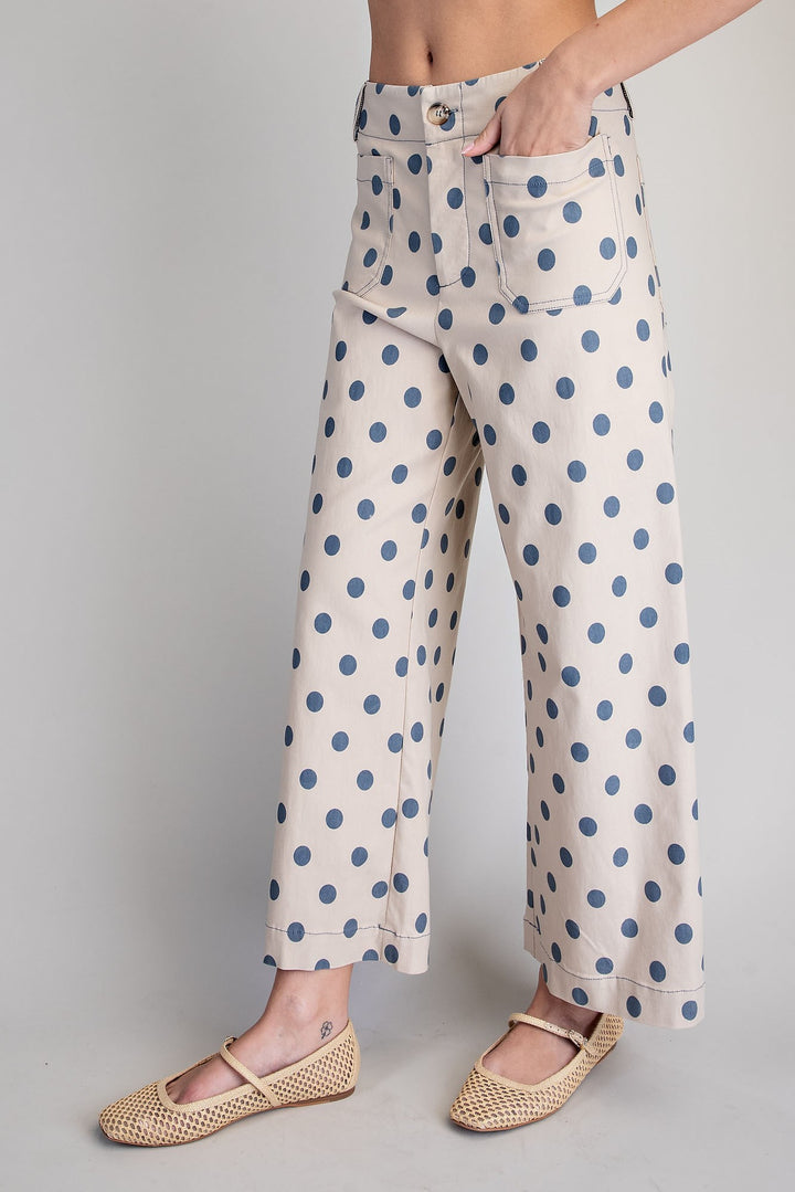 Polka dot pants worn by a person on a plain background
