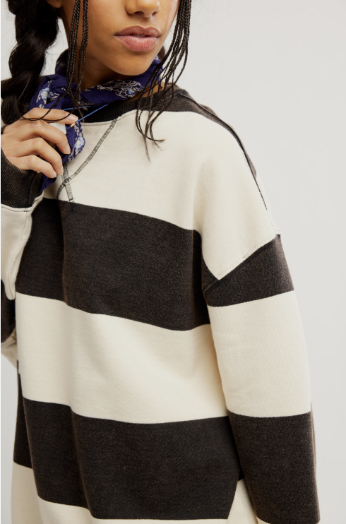 Woman wearing black and white stripe crewneck on white background